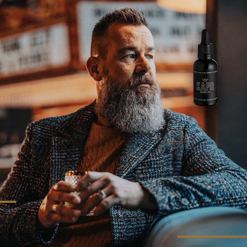 KAPR Beard Oil – man gebruikt premium baardolie in barbershop.